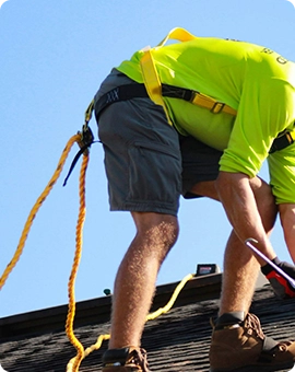 man working with cable on roof