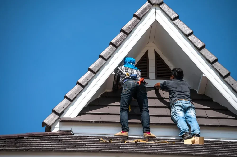 Professional roofing team installing tile roof with safety gear and harnesses in Palo Alto California